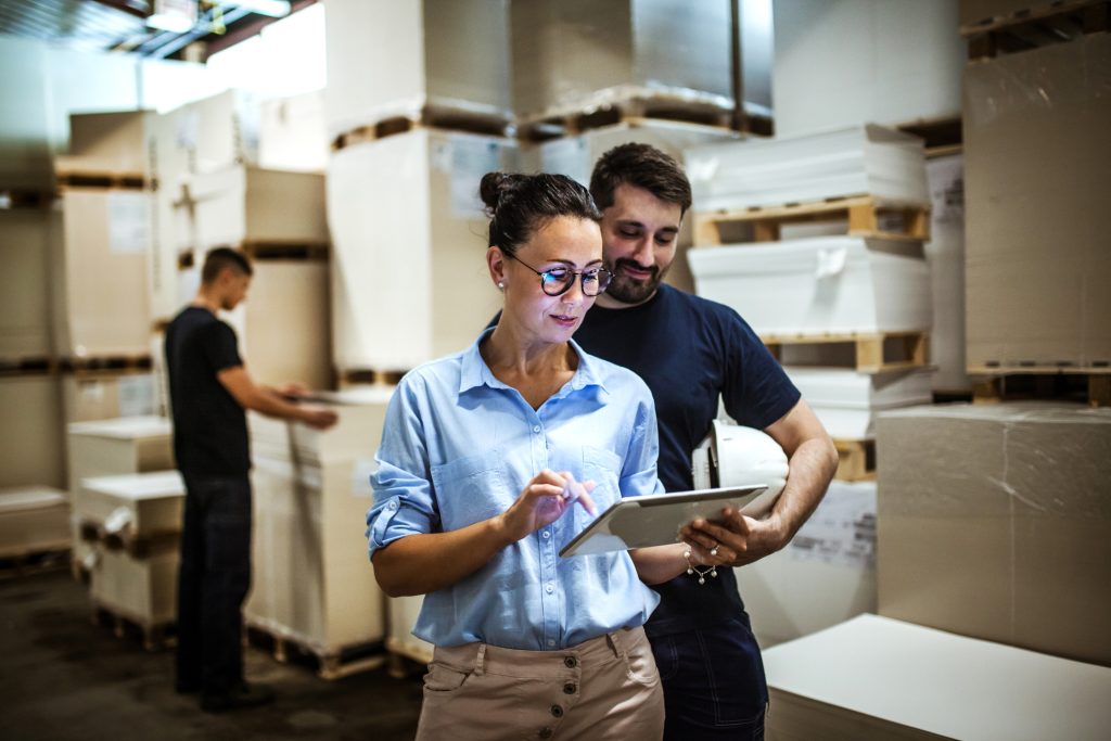 Warehouse worker using business phone